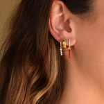 14K gold-plated Cornicello hoop earrings displayed on a model's ears