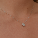Woman showcasing a clover necklace made of sterling silver