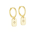 A pair of 14K gold plated hoop earrings with a round, star-cut white cubic zirconia stone.