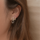 Detailed image showing the craftsmanship of the two-tone pearl studs