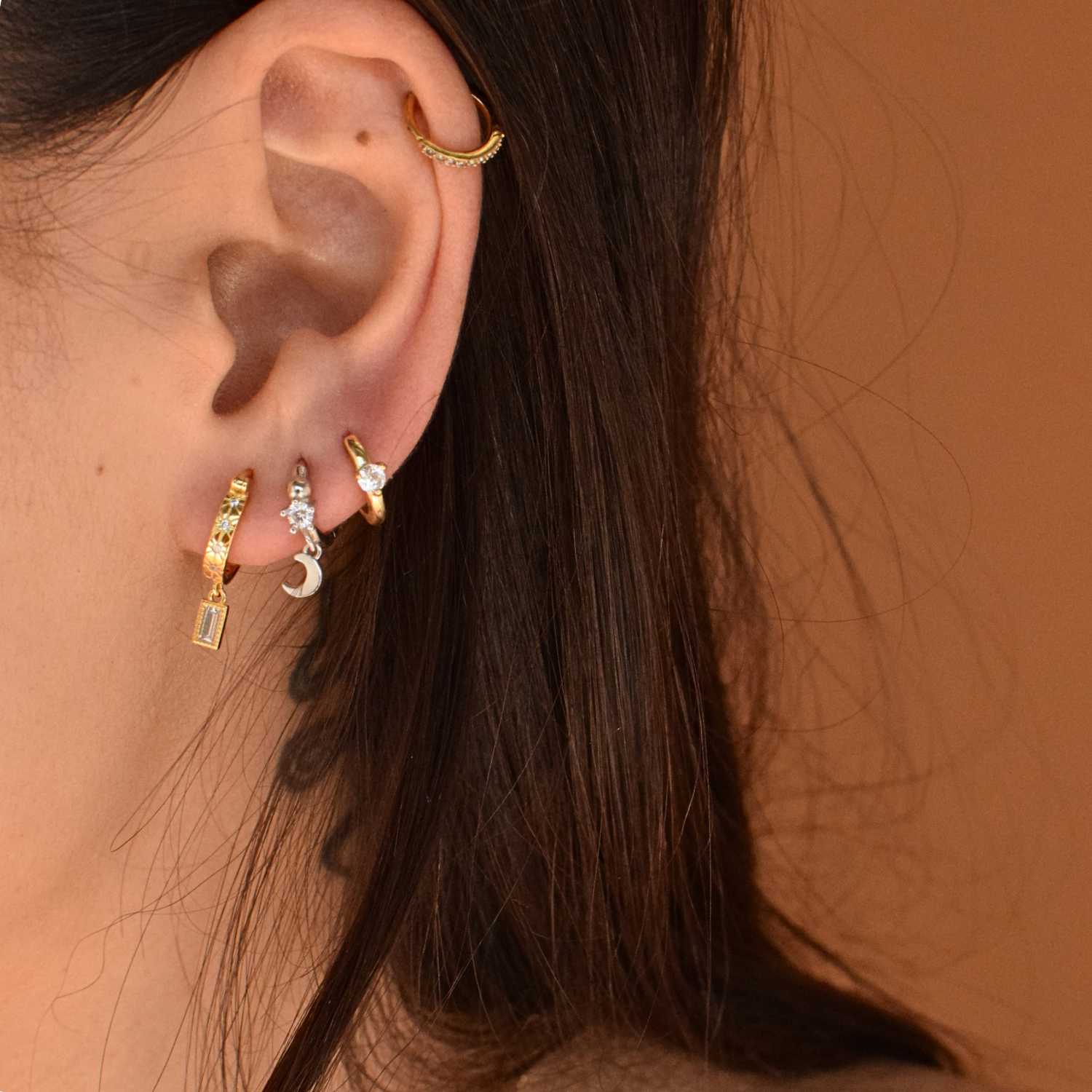Close-up of a woman wearing the 14K Gold Plated Skylar Hoops earrings