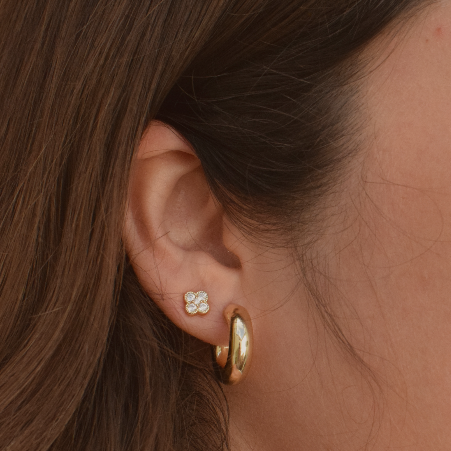 Close-up of a woman modeling a 'Samantha Hoop' earring in 14K Gold Plated design