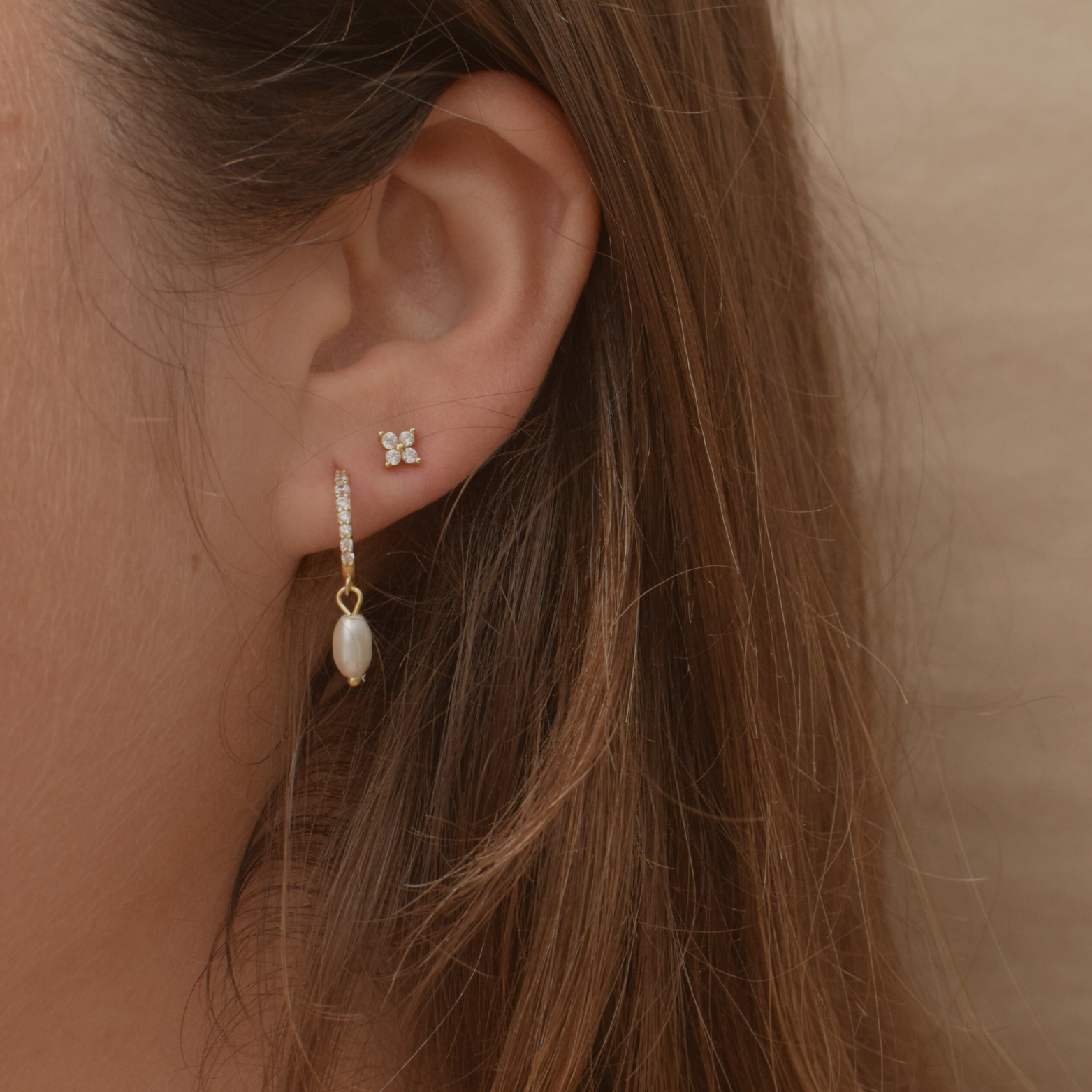 Close-up of Kayla hoops in 14K gold plating adorned with pearls