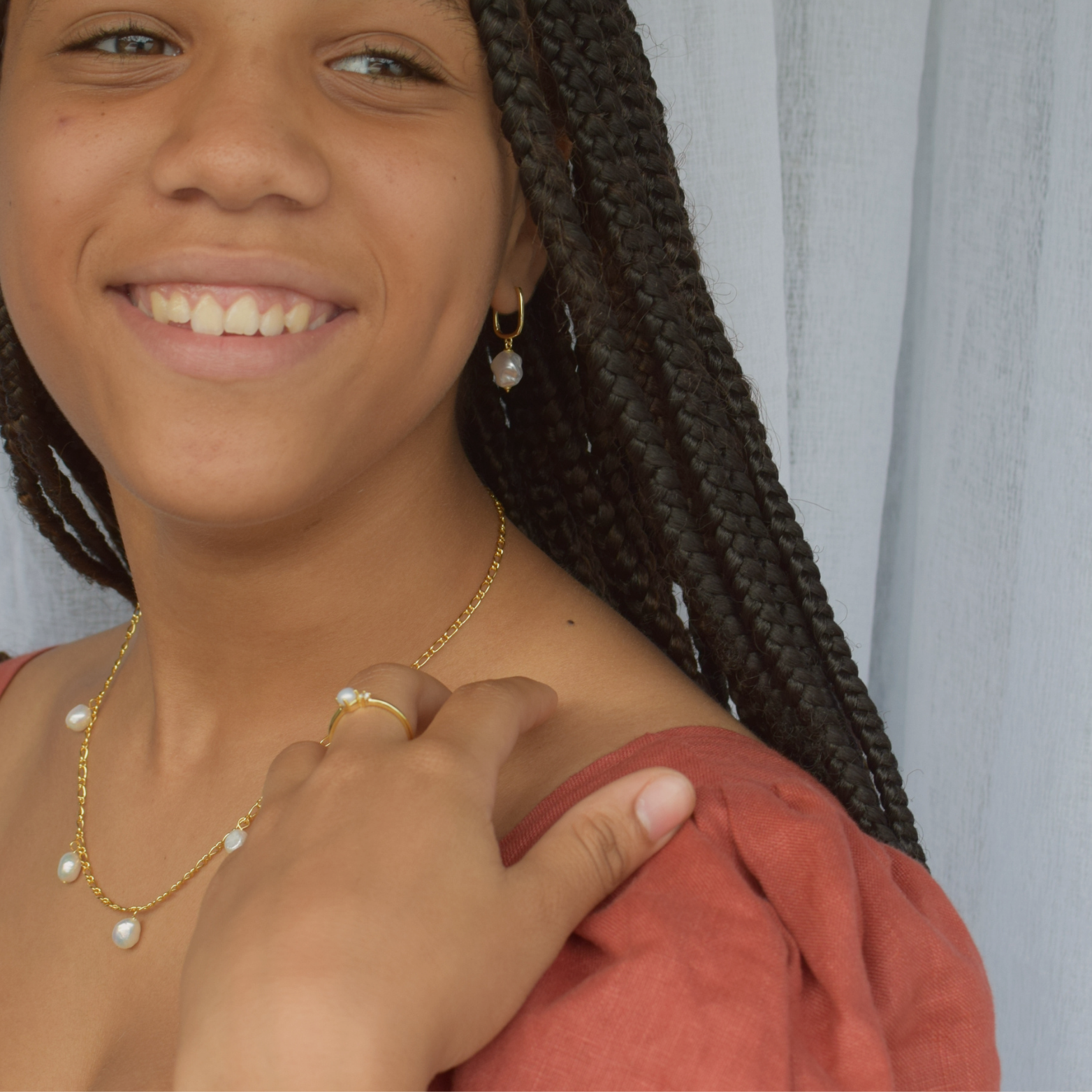 Close-up of a young woman wearing the 'Meah Hoops' 14K Gold Plated earrings