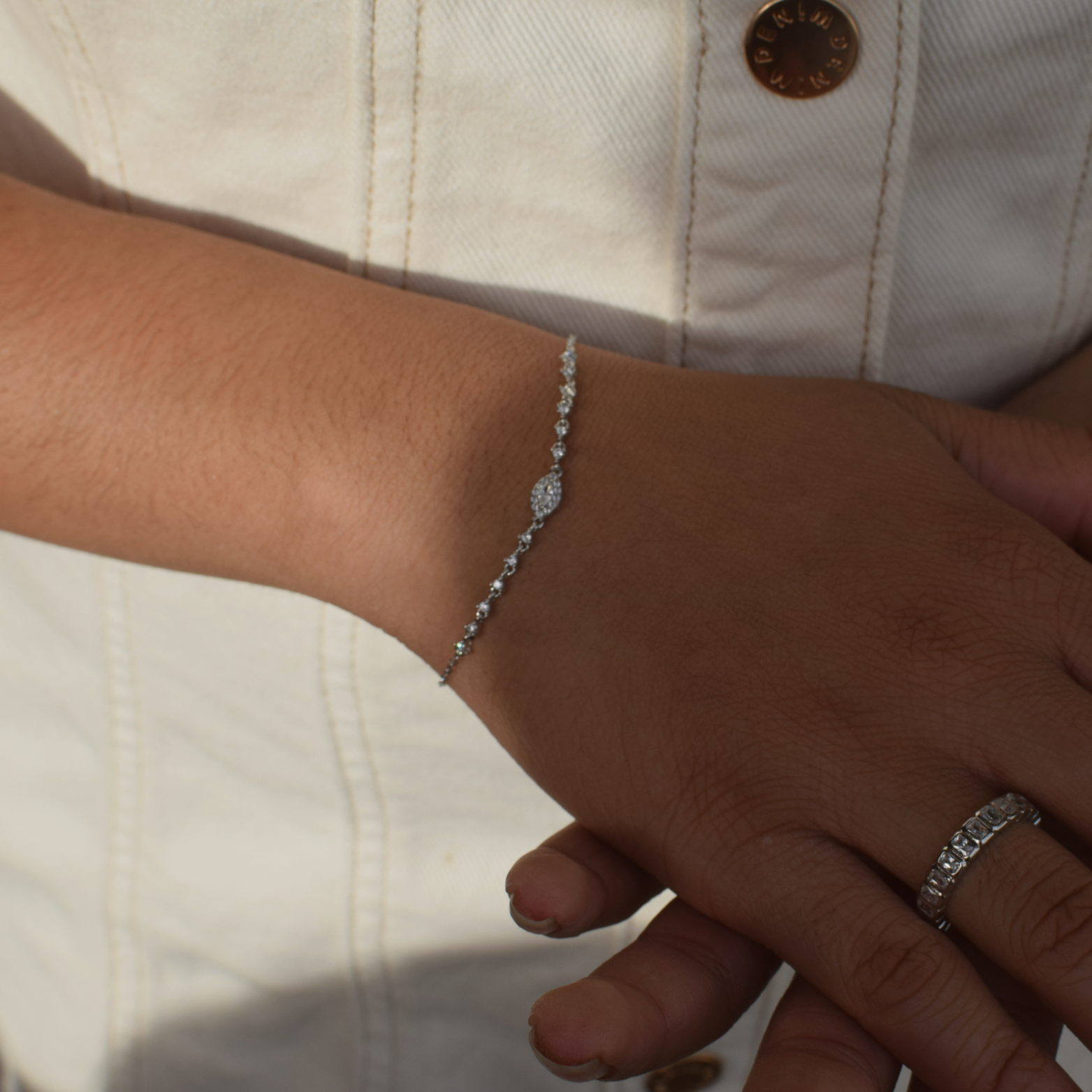 Elegant Ashley bracelet in sterling silver adorned on a female's wrist alongside a matching ring