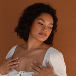 Woman wearing a 14K gold plated 111 Angel Number Necklace with a white top
