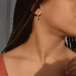 Close-up of a woman wearing 14K gold-plated Lila Hoop earrings