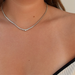Side view of a woman wearing a graduating sterling silver Graduating Necklace