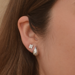 Sterling silver teardrop stud earrings modeled by a woman