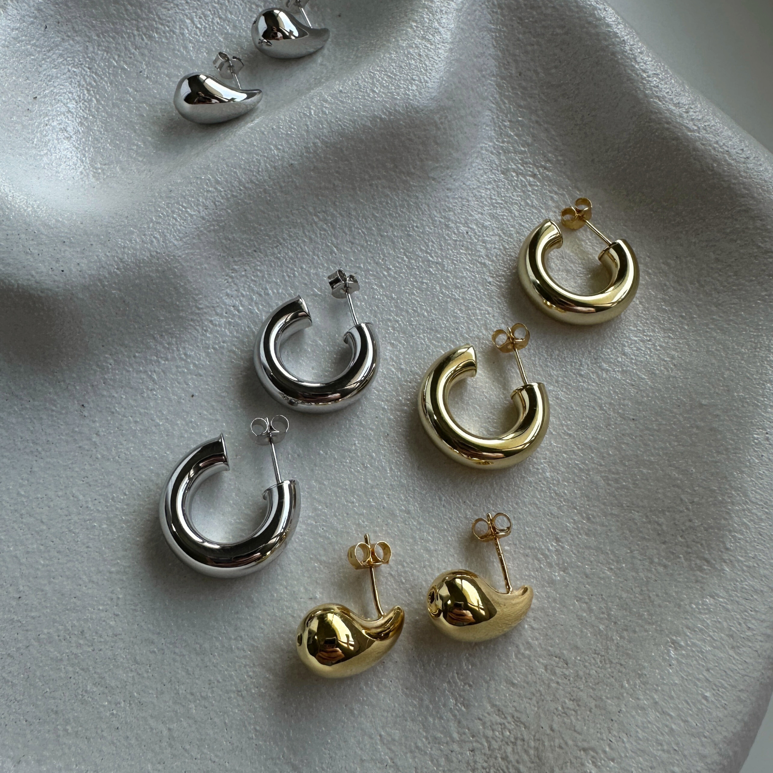 Samantha collection display featuring sterling silver hoop earrings in various sizes