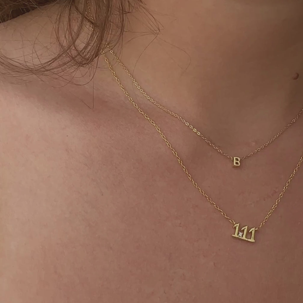Close-up of the 111 Angel Number Necklace in 14K gold plating with our stunning Initial Necklace