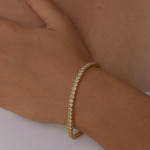 Close-up of a 14K gold plated Baguette Tennis Bracelet on a woman's wrist