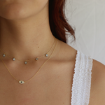 Woman showcasing the Zephyr necklace with its 14K gold plating