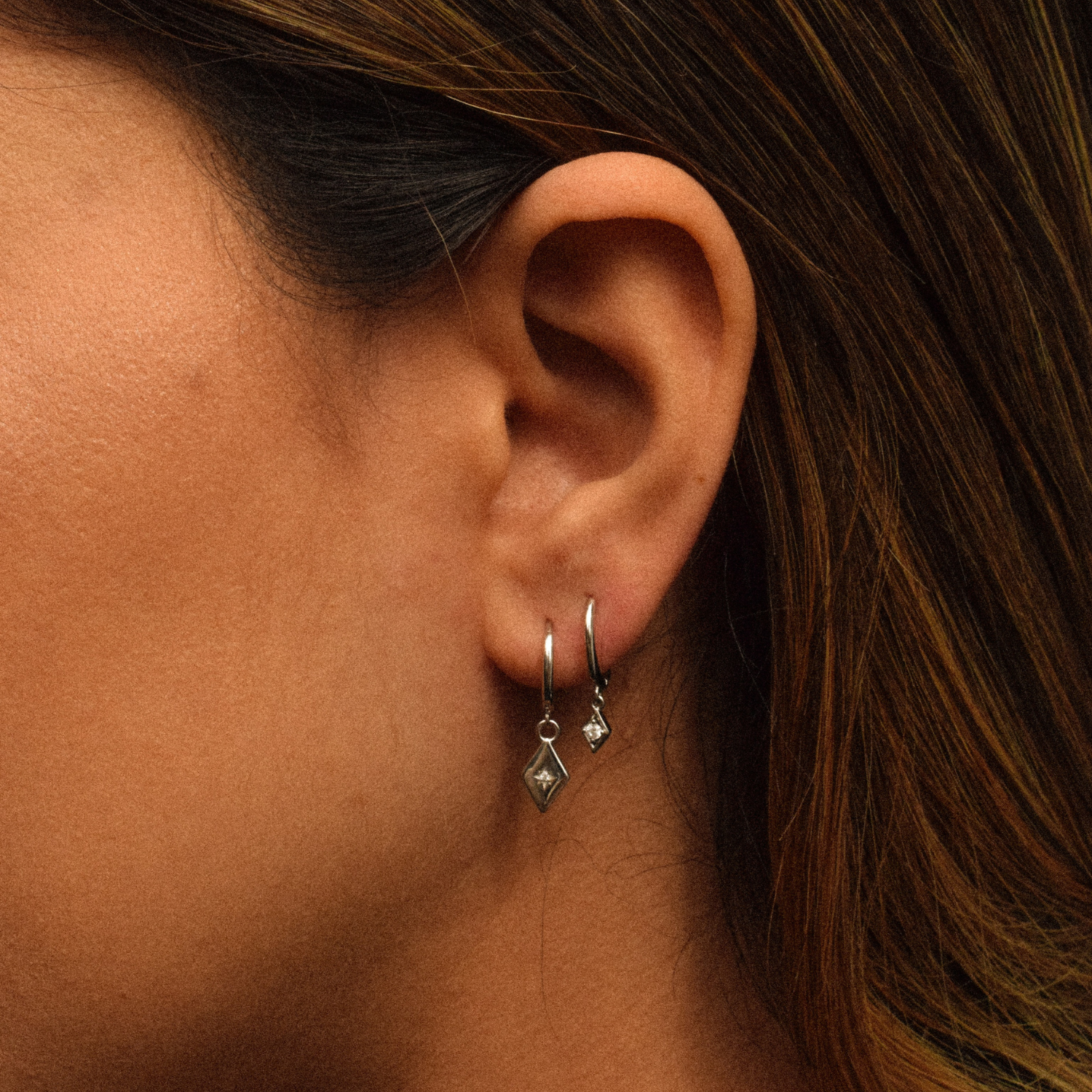 Close-up of a woman adorned with the Aurora Hoops Sterling Silver earrings
